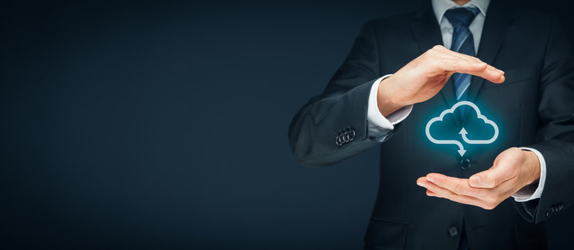 Cloud computing security concept - connect devices to cloud. Businessman or information technologist with cloud computing icon and protective gesture.