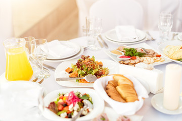 Restaurant table with food. Tasty appetizers, salads. Different meals for the guests on the wedding table
