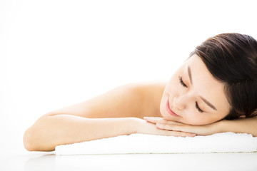 Obraz na płótnie Canvas Beautiful woman lying down on towel during skin care treatment.