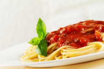 Tasty colorful appetizing cooked spaghetti italian pasta with tomato sauce bolognese and fresh basil. Closeup.