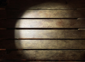 Lighting wood board in darkness use for background.
