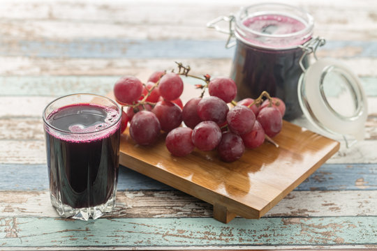 Fresh grape juice (compote) and grapes on vintage table