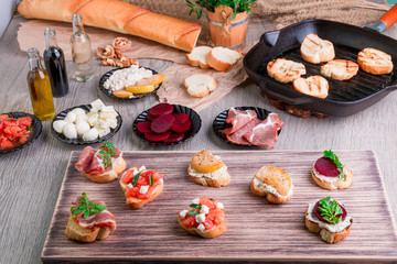 Set of bruschetta on wooden board. Ingredient for crostini. Italian food.