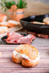 Bruschetta with creame cheese and pear on wooden background.