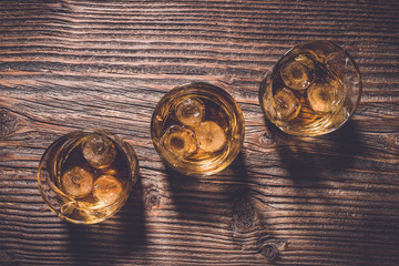Overhead shot of whiskey glasses with ice cubes