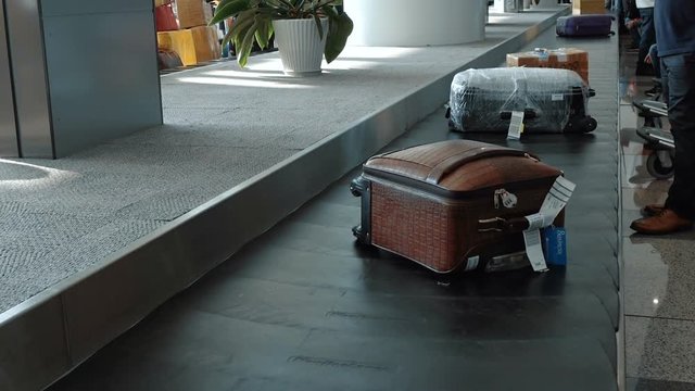Luggage travels on a conveyor belt at the airport. Full HD stock footage.
