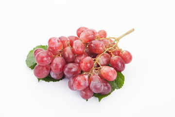 Ripe red grape with leaves isolated on white