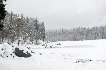 On the frozen lake during a snowfall. Fusine, Udine