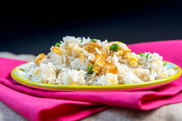 Homemade Chinese fried rice with vegetables and fried eggs