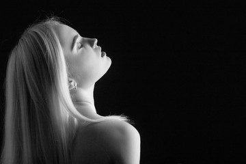 sensual girl with closed eyes on black background