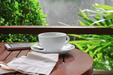 coffee cup on the wood floor background