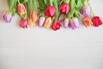tulips on light wood background