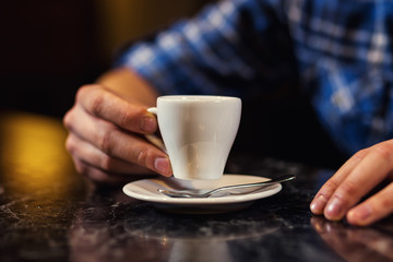 handsome young man drinking coffee while sitting at bar counter.enjoying coffee,Cafe Coffee Caffeine Casual Relaxation Style Concept.Young fashion man / hipster drinking espresso coffee in city cafe