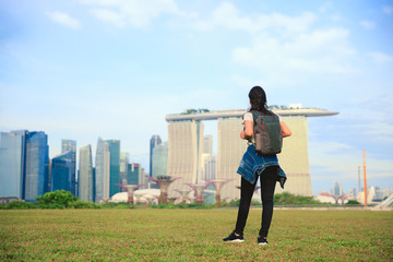 Happy traveler woman in Singapore