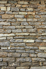 Natural grunge brown stone wall background and texture.