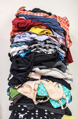 Stack of clean colourful clothes piled up high