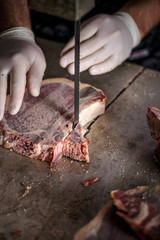 Butcher is slicing meat