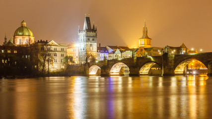 Fototapeta na wymiar Charles bridge at night with water reflection, Prague, Czechia.