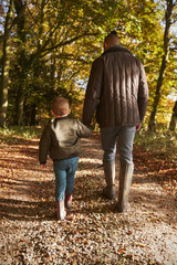 Fototapeta premium Father And Son On Autumn Walk In Woodland Together