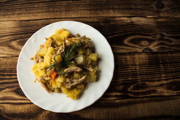 baked potatoes with meat, carrots and onions