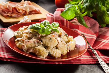 Potato gnocchi, Italian potato dumplings with cheese sauce, ham