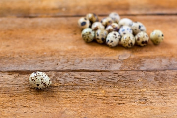 quail eggs on old brown wooden background