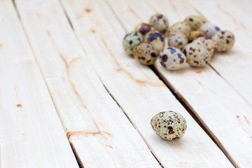 quail eggs on wooden background.