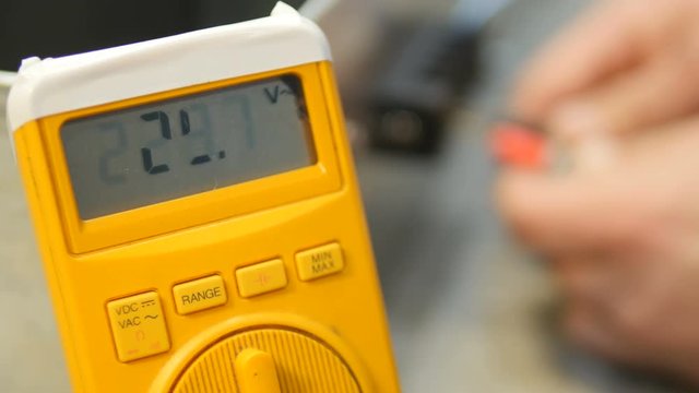 Engineer working with multimeter in laboratory. 4K.