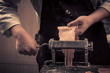 The chef makes fresh spaghetti from scratch.