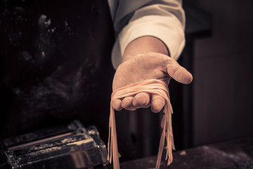 The chef makes fresh spaghetti from scratch.