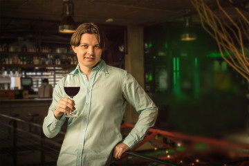 Handsome man in bar on blurred background