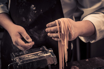 The chef makes fresh spaghetti from scratch.