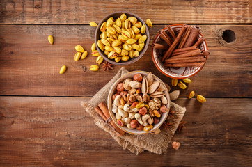 Mix of nuts and cinnamon on a old rustic table. Top view