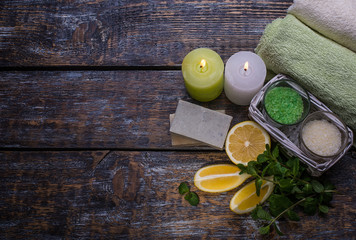 spa setting  therapy with Slices of lemon, mint sprig, soap, candles   isolated on  wooden background.