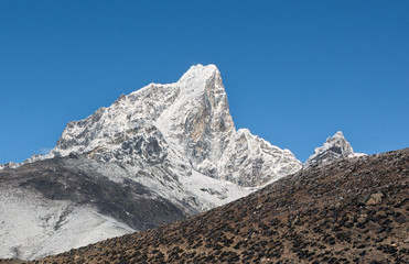 Panoramic view to the peak Tabuche from the village of Dingboche in the valley of Chukung district...