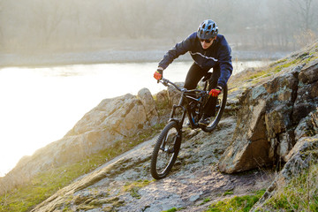 Obraz premium Enduro Cyclist Riding the Mountain Bike Down Beautiful Rocky Trail. Extreme Sport Concept. Space for Text.