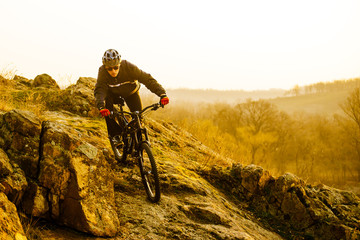 Fototapeta na wymiar Enduro Cyclist Riding the Mountain Bike Down Beautiful Rocky Trail. Extreme Sport Concept. Space for Text.