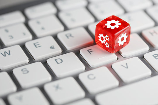 Rot farbener / roter W&uuml;rfel auf Tastatur mit Zahnr&auml;der / Einstellungen Setup Konfiguration