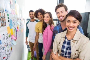 Happy graphic designer standing together in office