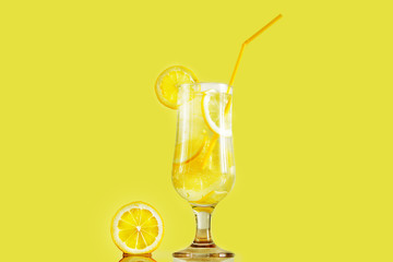 Lemonade drink of soda water, lemon and mint leaves in a glass on a background. Summer refreshing drink, lemon and seashells