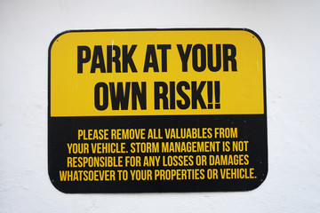 Park at your own risk sign