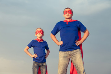 Father and daughter playing superhero at the day time.