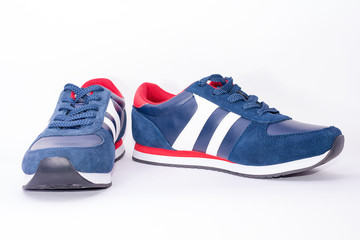 Bright blue sneakers on a white blurry background. Sport shoes. Healthy lifestyle.