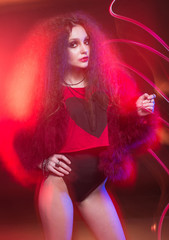 Fashion art portrait of young attractive woman in mixed light.