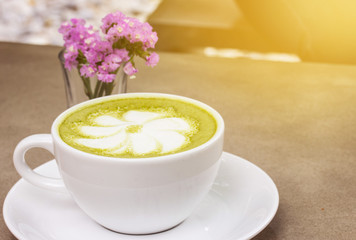 Obraz na płótnie Canvas milk green tea on wooden floor and yellow tone