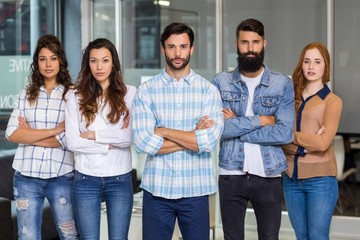 Portrait of male and female executives standing 