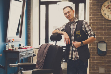 Barber invites to have seat on chair at barbershop