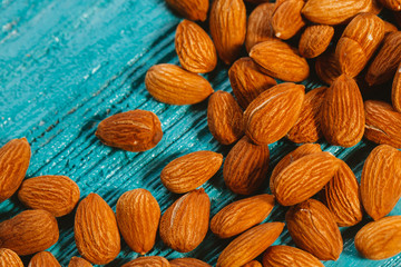 handful of almonds on a blue wooden background