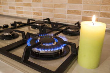 Closeup shot of blue fire from domestic kitchen stove. Gas cooker with burning flames propane gas...