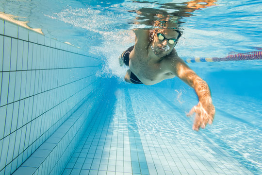 Freestyle swimmer underwater in swimming lane